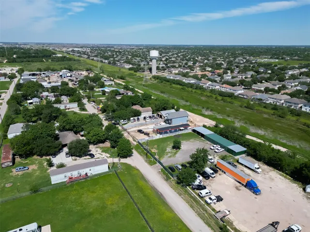 an aerial view of residential houses with outdoor space