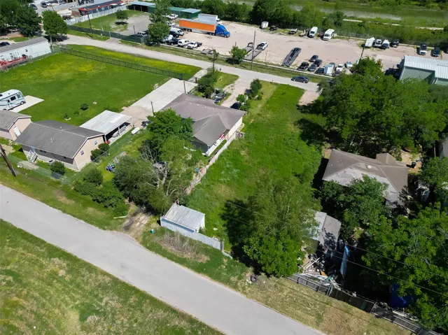 an aerial view of a residential houses with outdoor space and street view