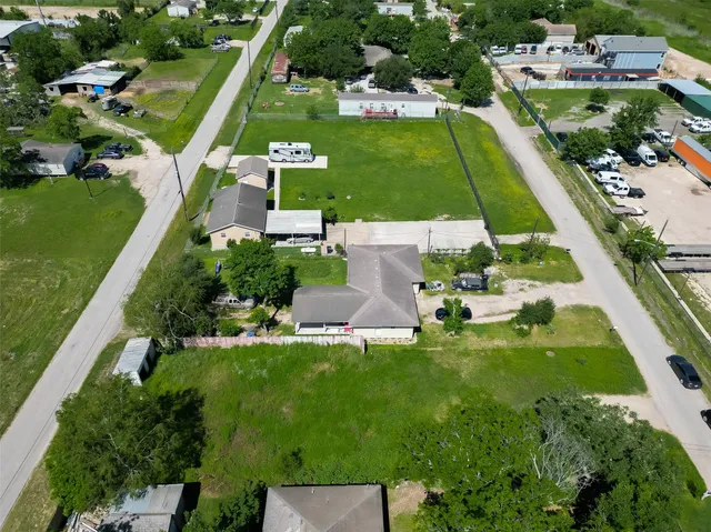 an aerial view of a house with garden space and street view