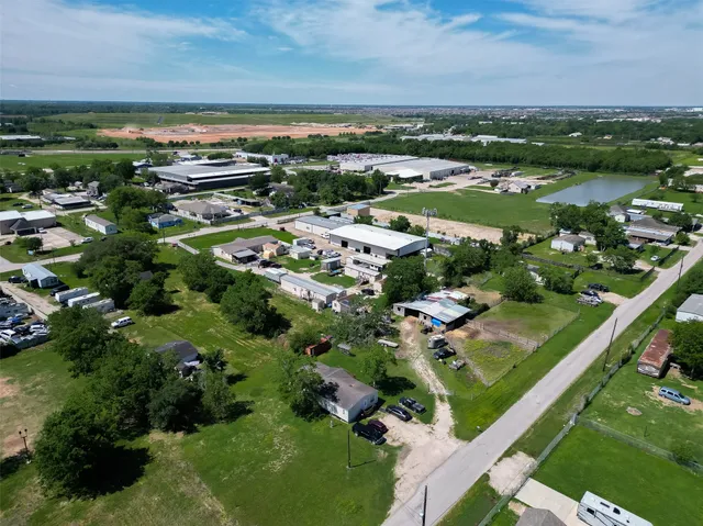 an aerial view of a city with lots of residential buildings ocean and mountain view in back