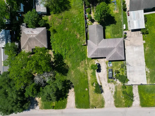 an aerial view of a house with garden space and street view