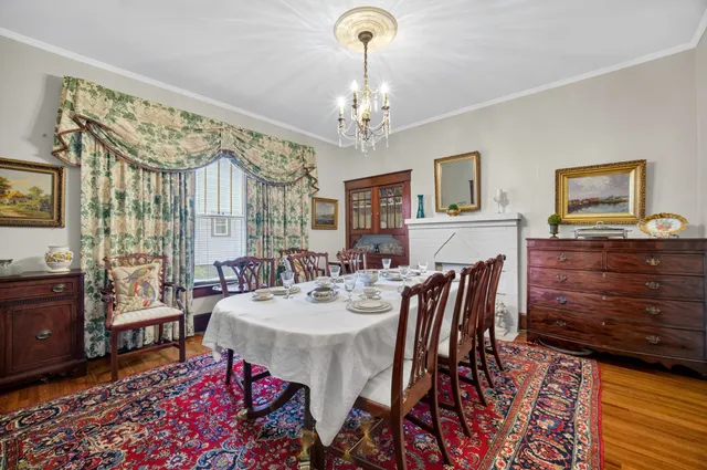a view of a dining room with furniture and chandelier