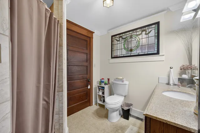 a white toilet sitting next to a bathroom sink