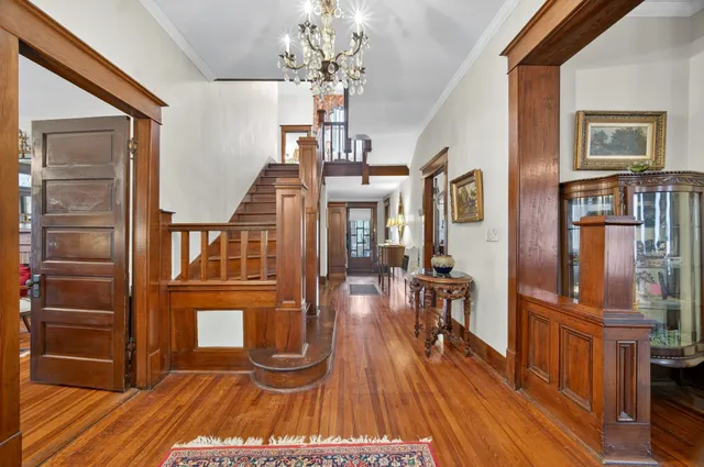 a living room with furniture a fireplace and wooden floor