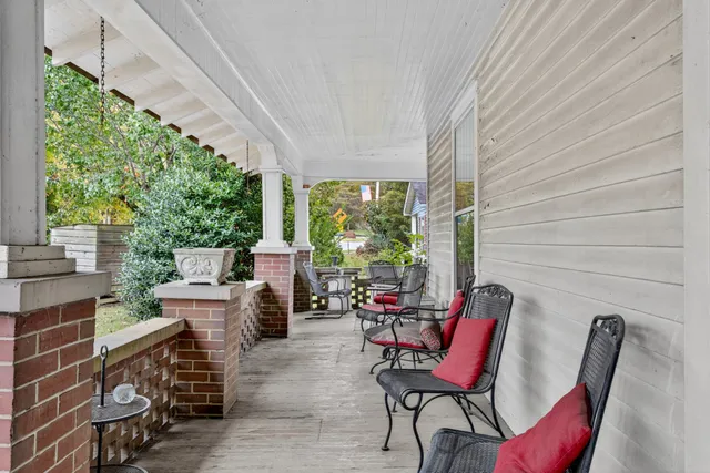 a view of a chairs and table in patio with a fire pit