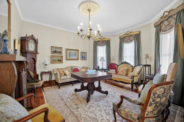 a living room with furniture and a chandelier