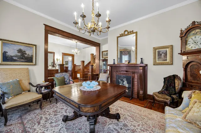 a living room with fireplace furniture and a chandelier
