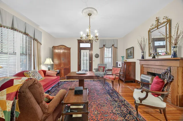 a living room with furniture windows and a chandelier