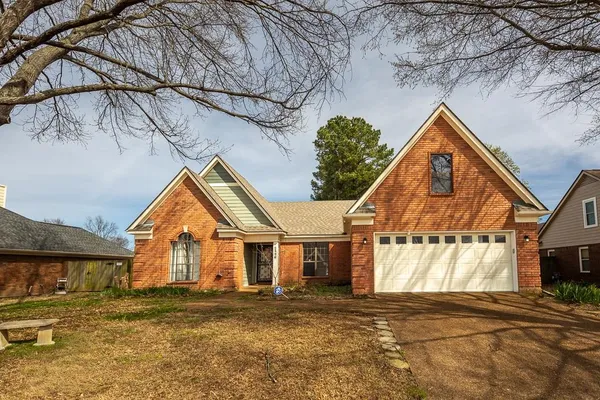 a view of residential houses with road and wooden fence