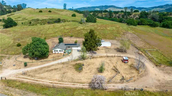 an aerial view of a house with a yard basket ball court and outdoor seating