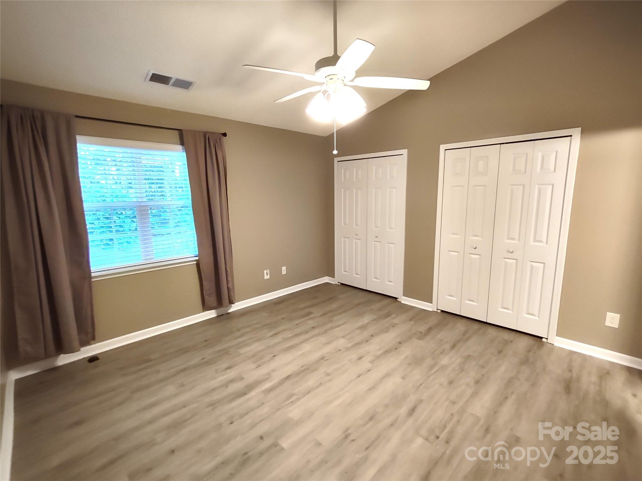 8338 Rudolph Road Charlotte, NC 28216 - Photo 11 of 15 wooden floor in an empty room with a window