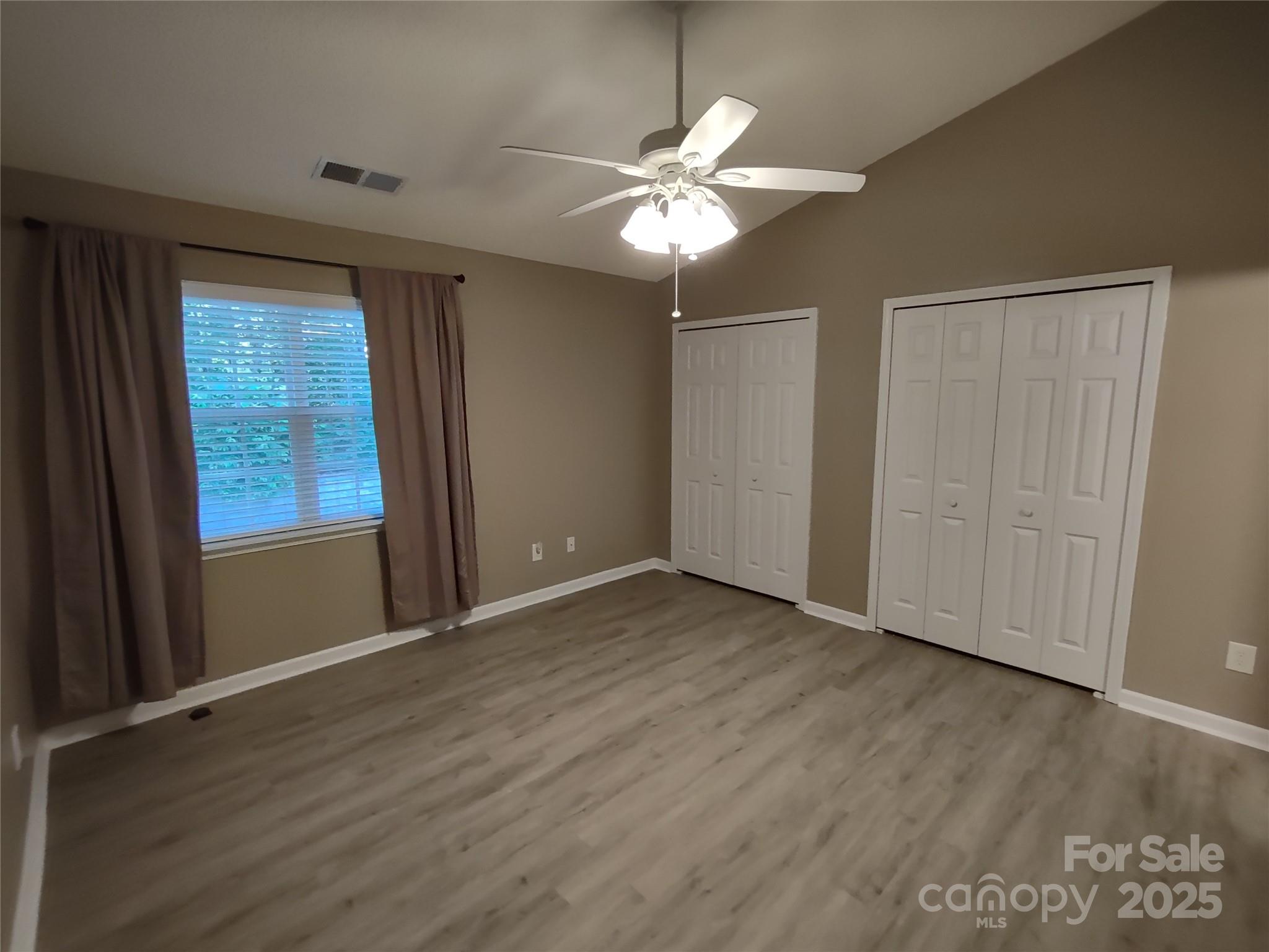 8338 Rudolph Road Charlotte, NC 28216 - Photo 12 of 15 a view of an empty room with wooden floor and a window