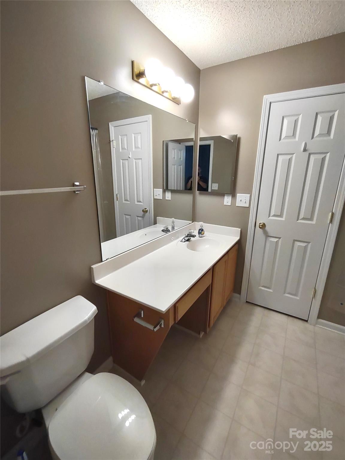 8338 Rudolph Road Charlotte, NC 28216 - Photo 13 of 15 a bathroom with a sink toilet and mirror