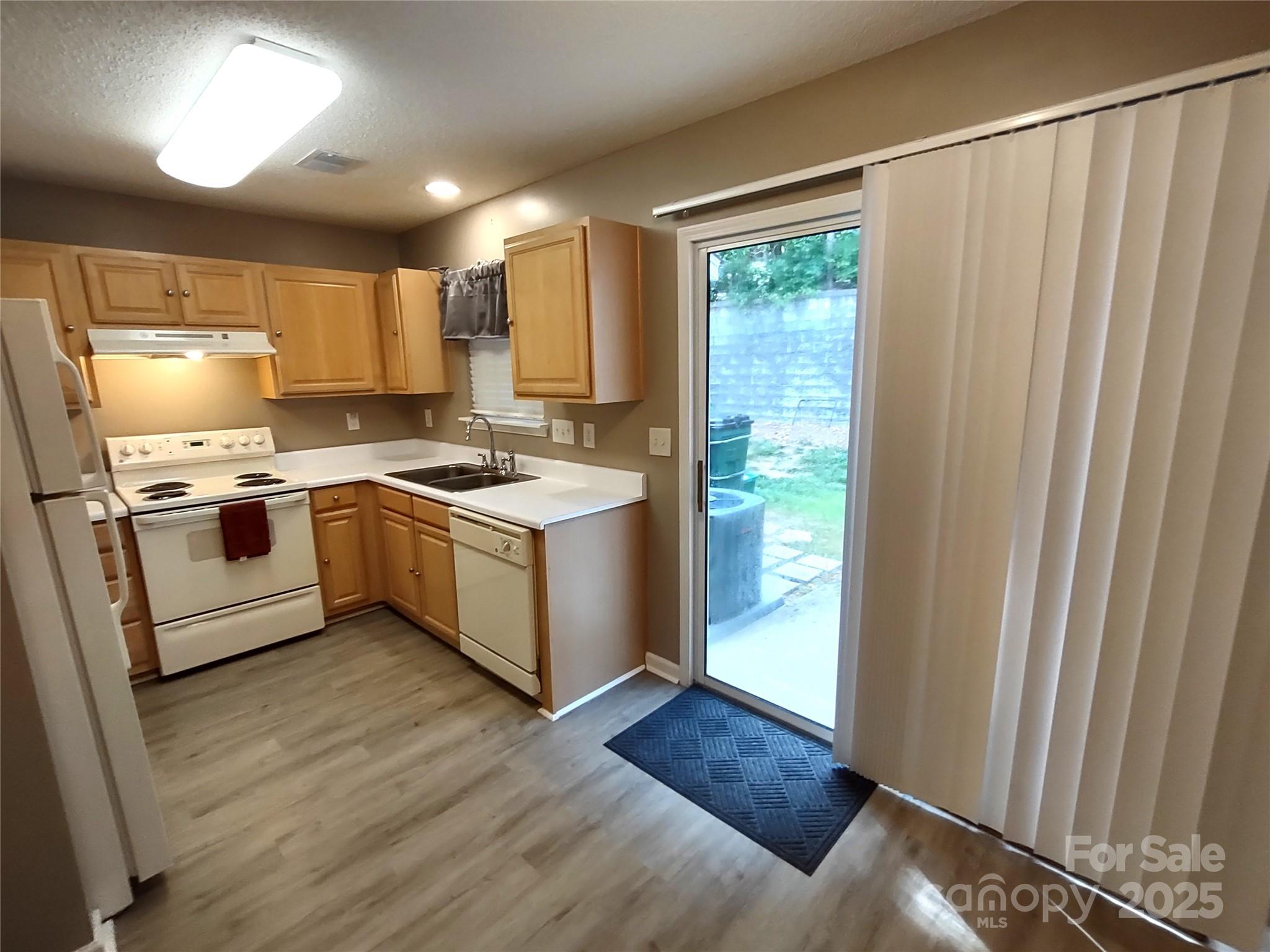 8338 Rudolph Road Charlotte, NC 28216 - Photo 6 of 15 a kitchen with stainless steel appliances granite countertop a stove a sink and a refrigerator