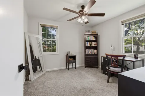 a view of a livingroom with furniture and windows