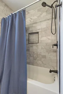 a bathroom with a shower and a bath tub