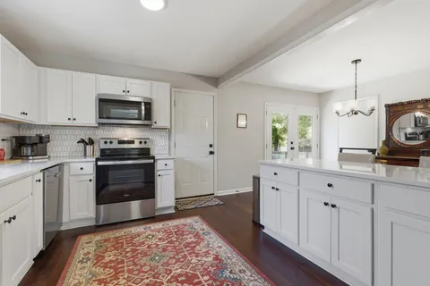 a kitchen with sink cabinets and stainless steel appliances