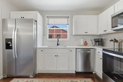 a kitchen with stainless steel appliances cabinets and a counter top space
