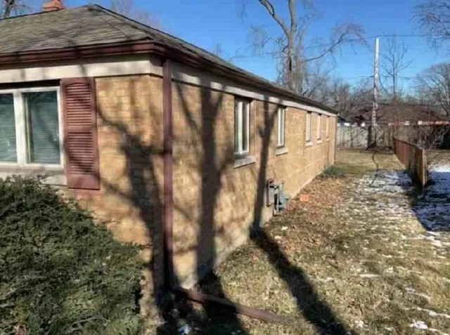 a view of a pathway of a house with a yard