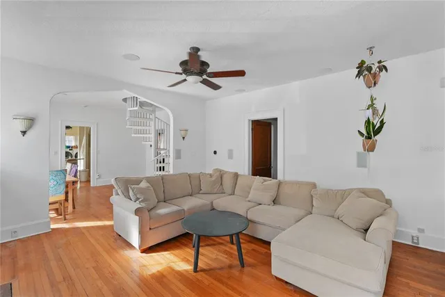 a living room with furniture and a wooden floor
