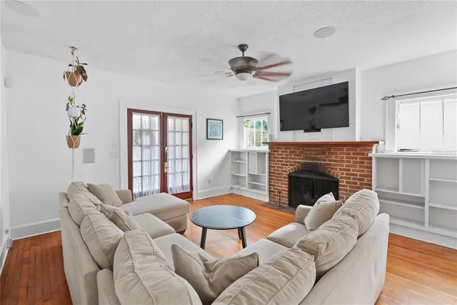 a living room with furniture a fireplace and a flat screen tv