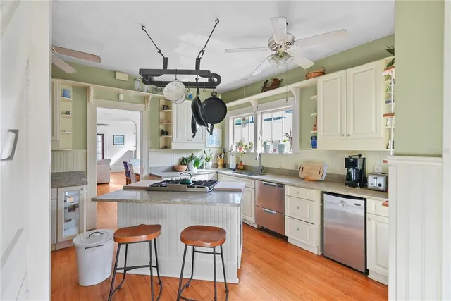 a kitchen with stainless steel appliances granite countertop a sink and cabinets
