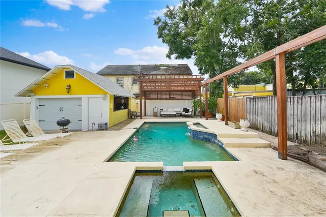 a view of a house with backyard and sitting area