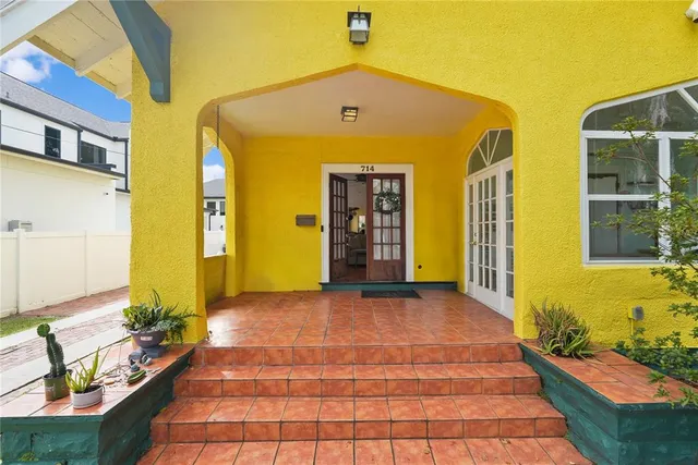 a front view of a house with many windows