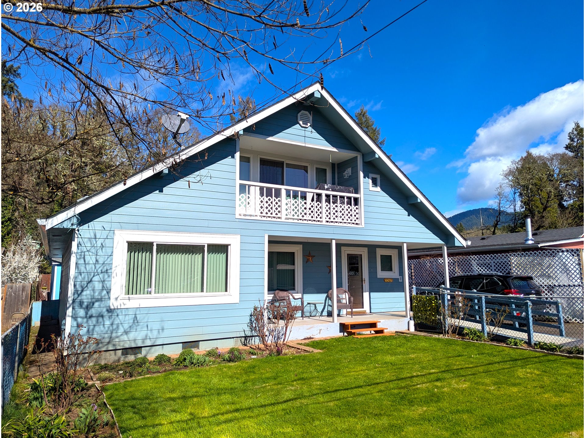 48379 7th Street Oakridge, OR 97463 - Photo 2 of 5 a front view of house with yard and outdoor seating