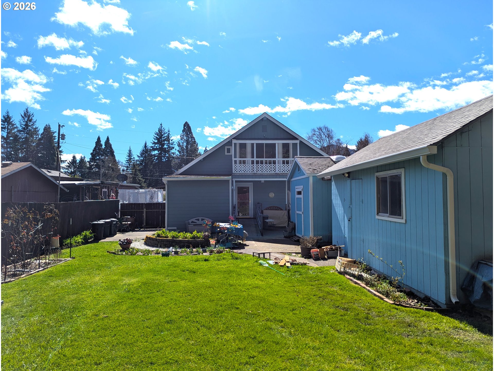 48379 7th Street Oakridge, OR 97463 - Photo 3 of 5 a front view of a house with garden and patio