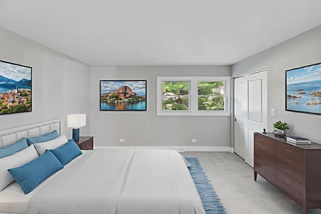 a bedroom with a bed and a dresser next to a window