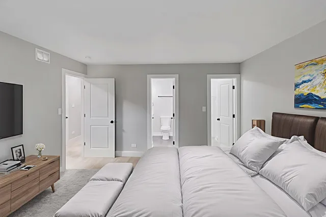 a bedroom with a bed and a couch