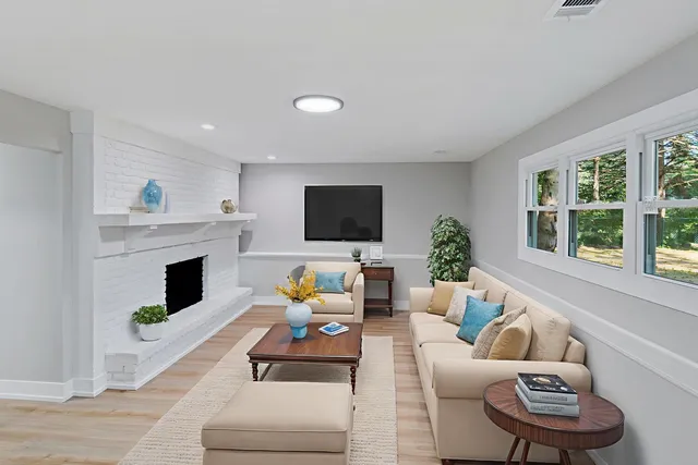 a living room with furniture fireplace and window