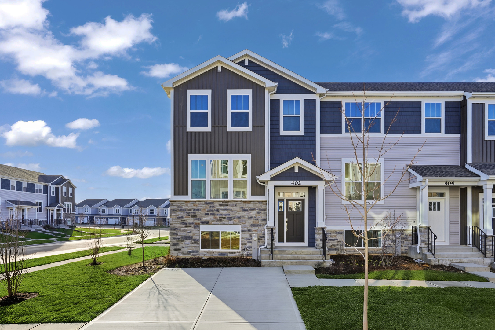 a front view of a house with a yard table and chairs