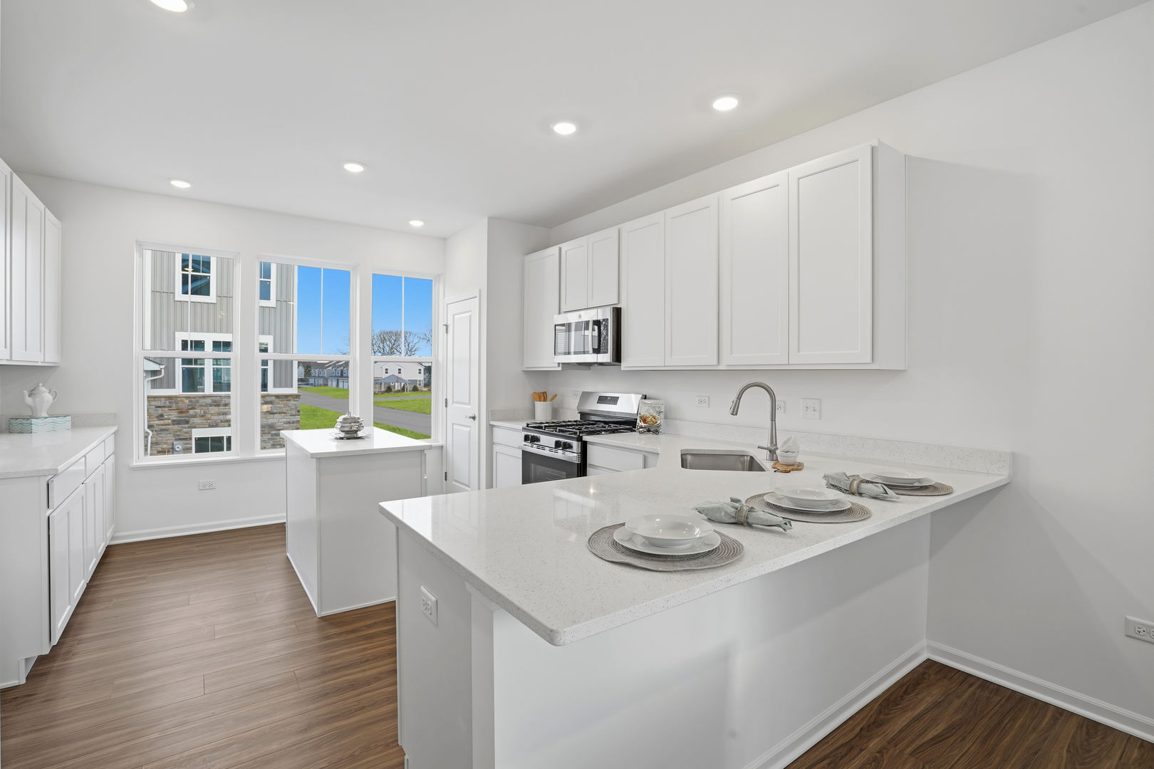 402 Red Oak Circle Volo, IL 60020 - Photo 4 of 20 a kitchen with a sink a stove cabinets and wooden floor