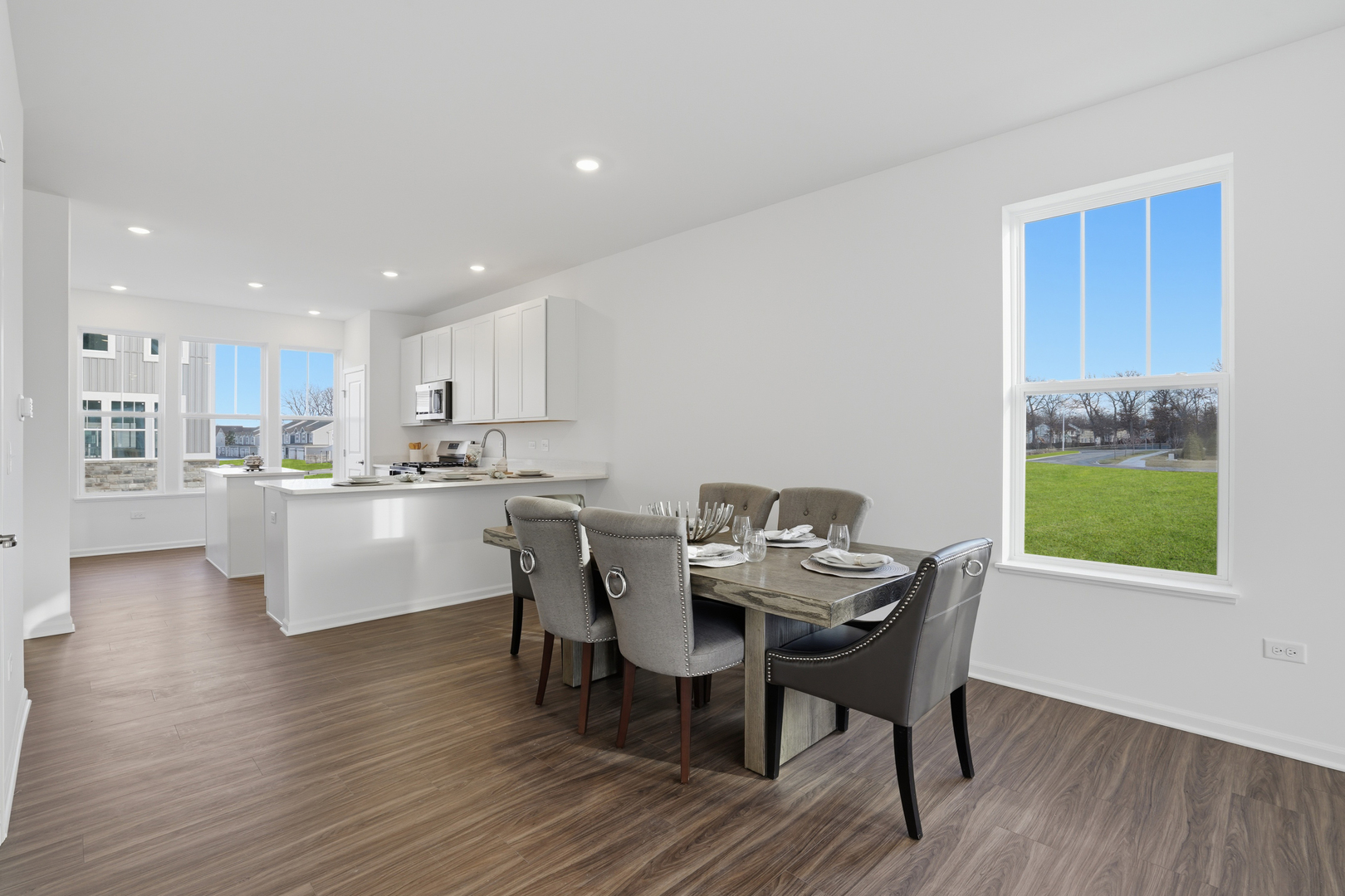 402 Red Oak Circle Volo, IL 60020 - Photo 6 of 20 a view of a dining room with furniture and wooden floor
