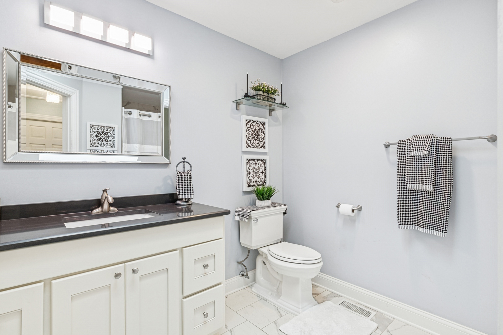 1341 Rose Boulevard Buffalo Grove, IL 60089 - Photo 13 of 19 a spacious bathroom with a granite countertop sink a toilet and a mirror