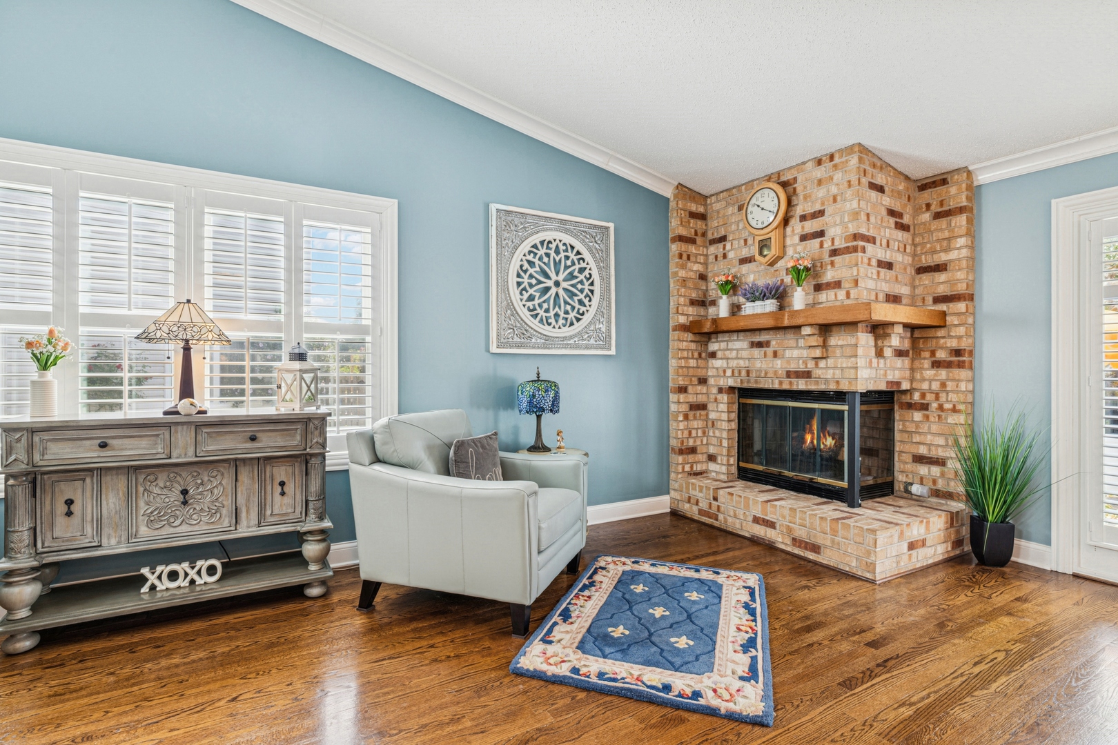 1341 Rose Boulevard Buffalo Grove, IL 60089 - Photo 5 of 19 a living room with furniture a flat screen tv and a fireplace