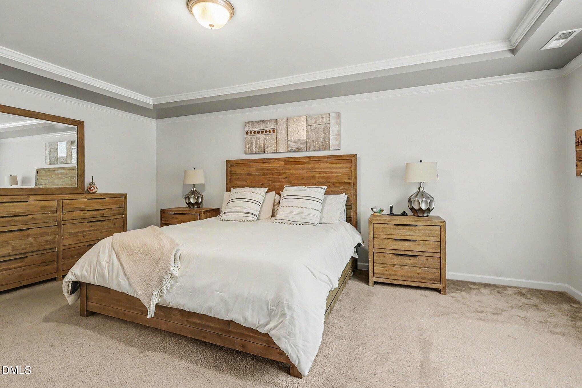 4366 Auburn Hills Drive Raleigh, NC 27616 - Photo 14 of 40 a bedroom with a bed and a cabinets
