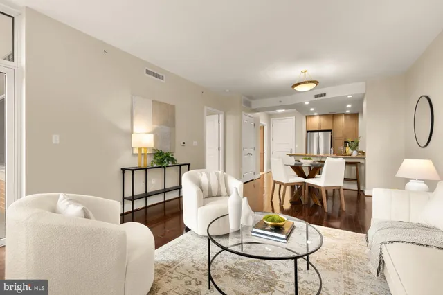 a living room with furniture and kitchen view
