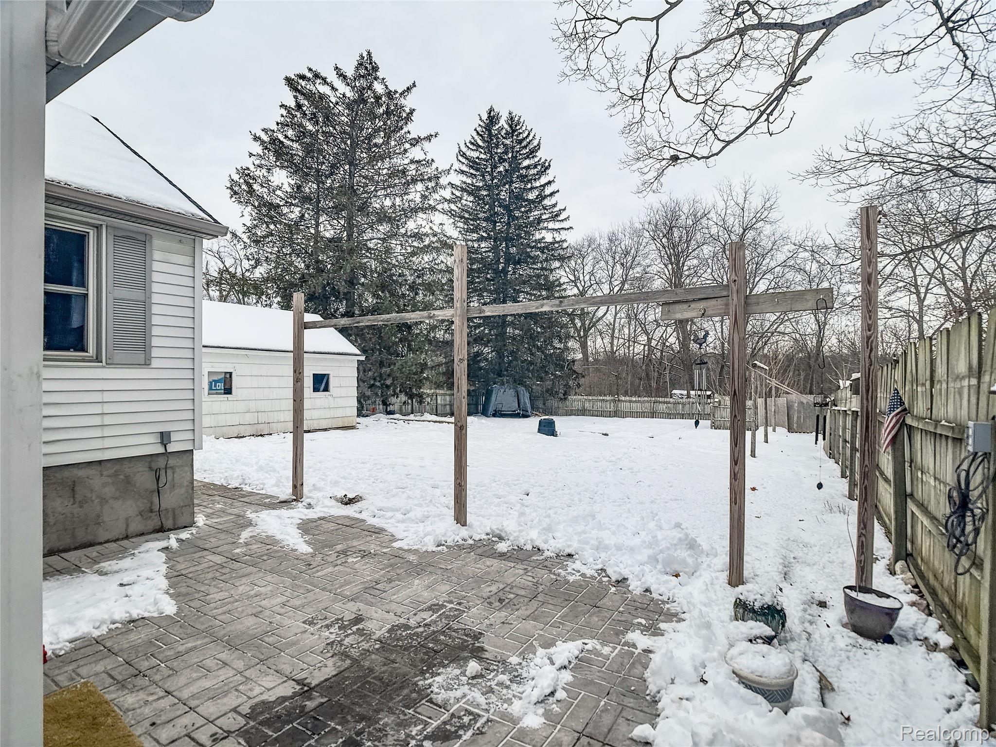 12034 North Seymour Road Montrose, MI 48457 - Photo 39 of 56 Snowy yard with a fenced backyard and a patio
