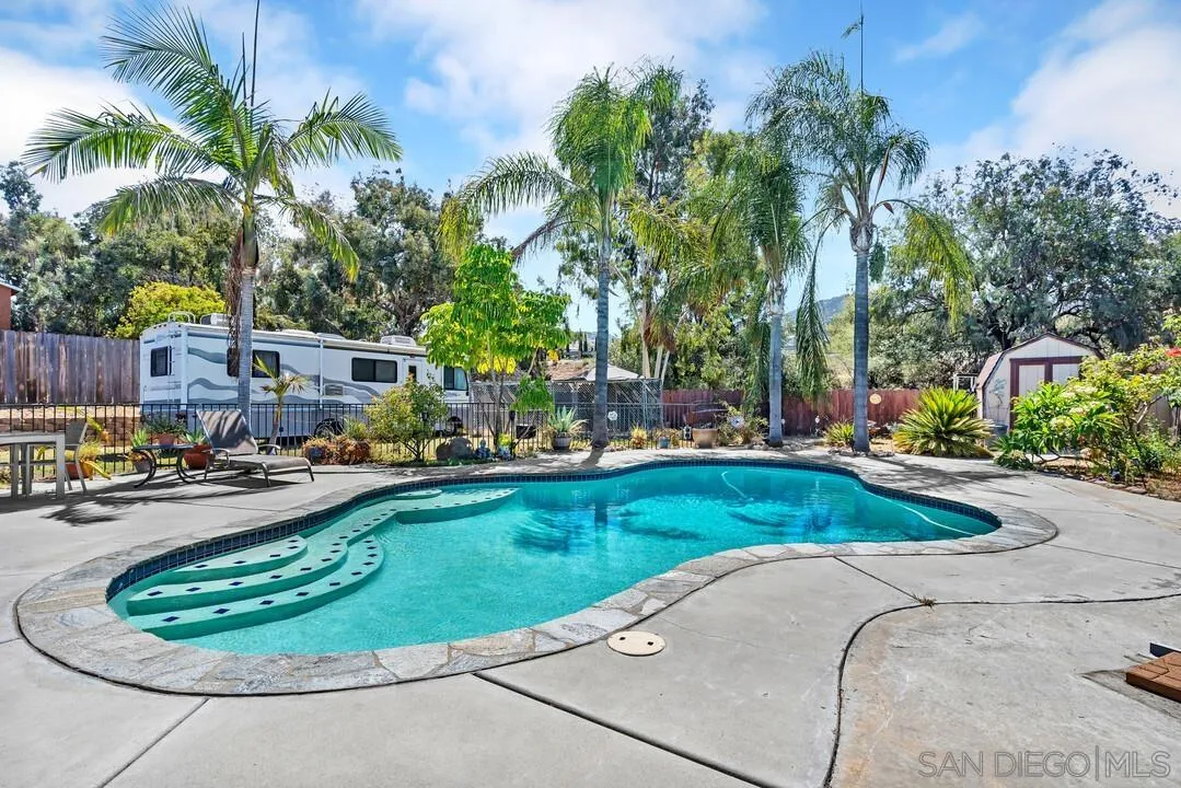 a view of a swimming pool and lounge chair