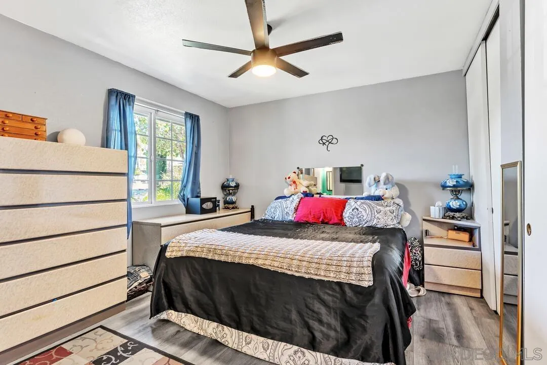 13611 Los Coches Road East El Cajon, CA 92021 - Photo 13 of 34 a bedroom with a bed and a dresser in it
