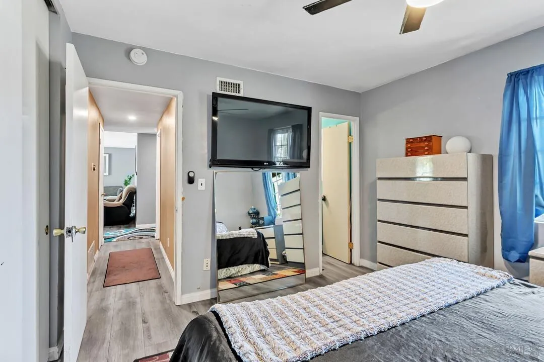 13611 Los Coches Road East El Cajon, CA 92021 - Photo 14 of 34 a bedroom with a bed and flat screen tv