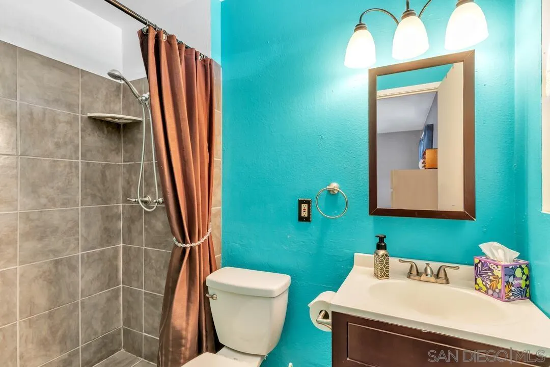 13611 Los Coches Road East El Cajon, CA 92021 - Photo 15 of 34 a bathroom with a toilet sink and mirror