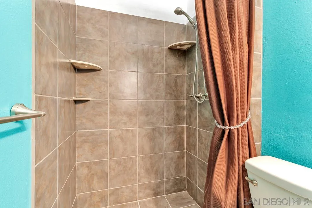 13611 Los Coches Road East El Cajon, CA 92021 - Photo 16 of 34 a bathroom with a shower a toilet and a sink