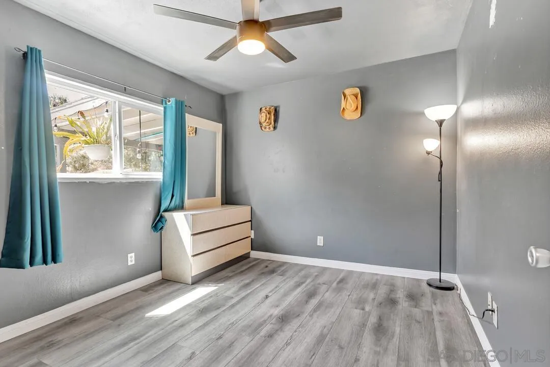 13611 Los Coches Road East El Cajon, CA 92021 - Photo 17 of 34 a room with window and wooden floor