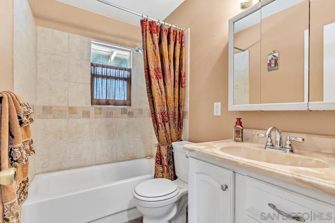13611 Los Coches Road East El Cajon, CA 92021 - Photo 19 of 34 a bathroom with a sink a toilet and a bathtub