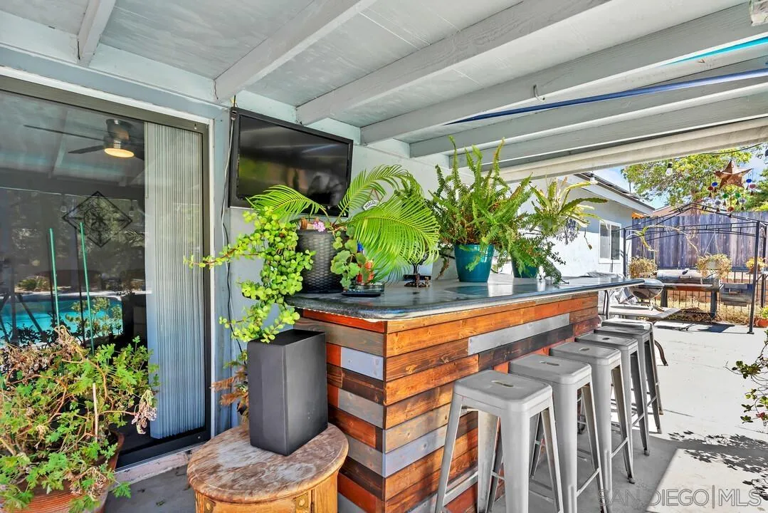 13611 Los Coches Road East El Cajon, CA 92021 - Photo 22 of 34 a wooden bench sitting in front of a building