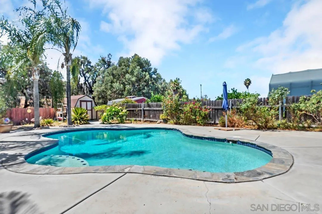 13611 Los Coches Road East El Cajon, CA 92021 - Photo 24 of 34 a view of a swimming pool with a sitting space